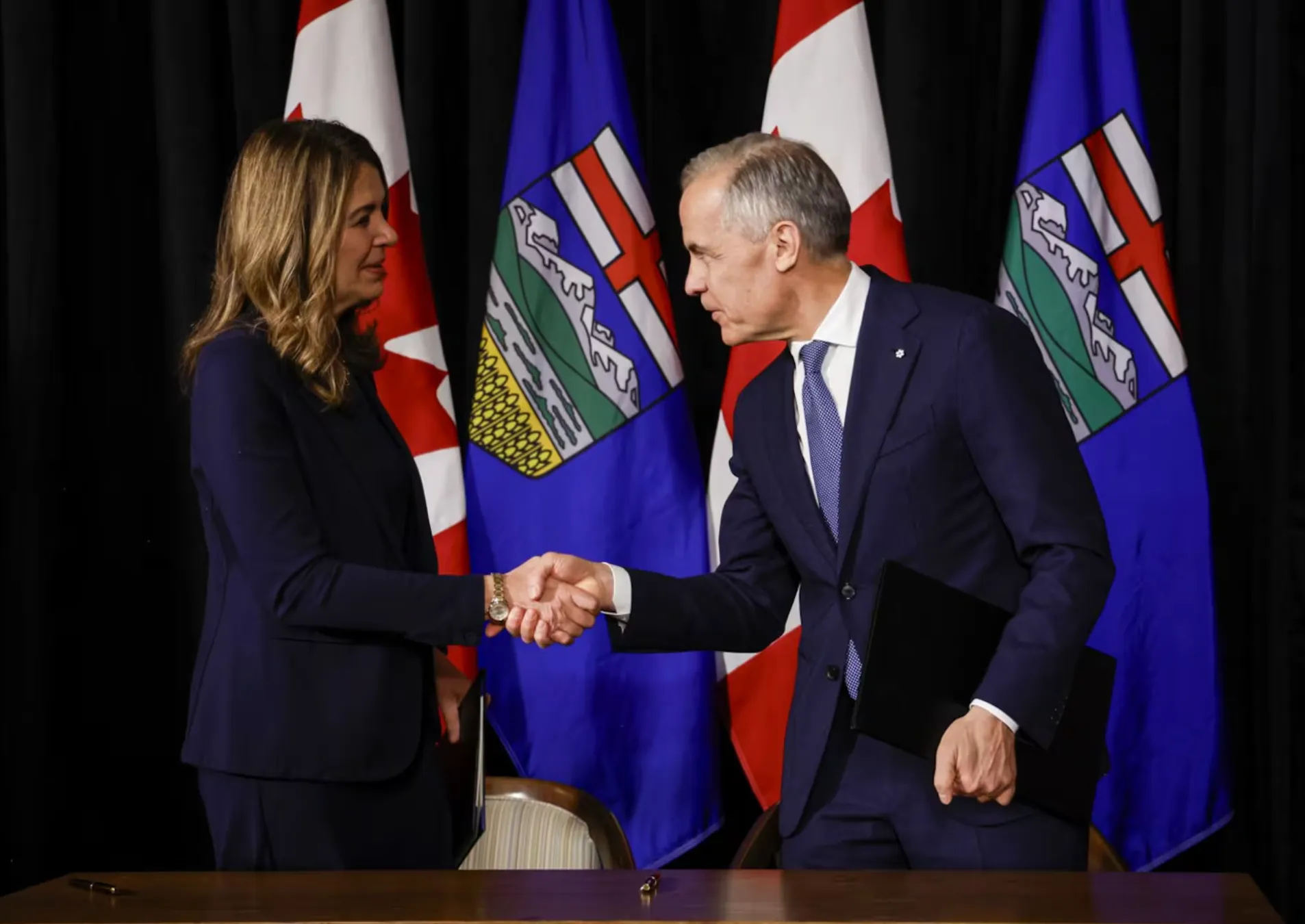 Prime Minister Mark Carney participates in a signing ceremony with Alberta Premier Danielle Smith in Calgary, Alta., Friday, May 15, 2026.